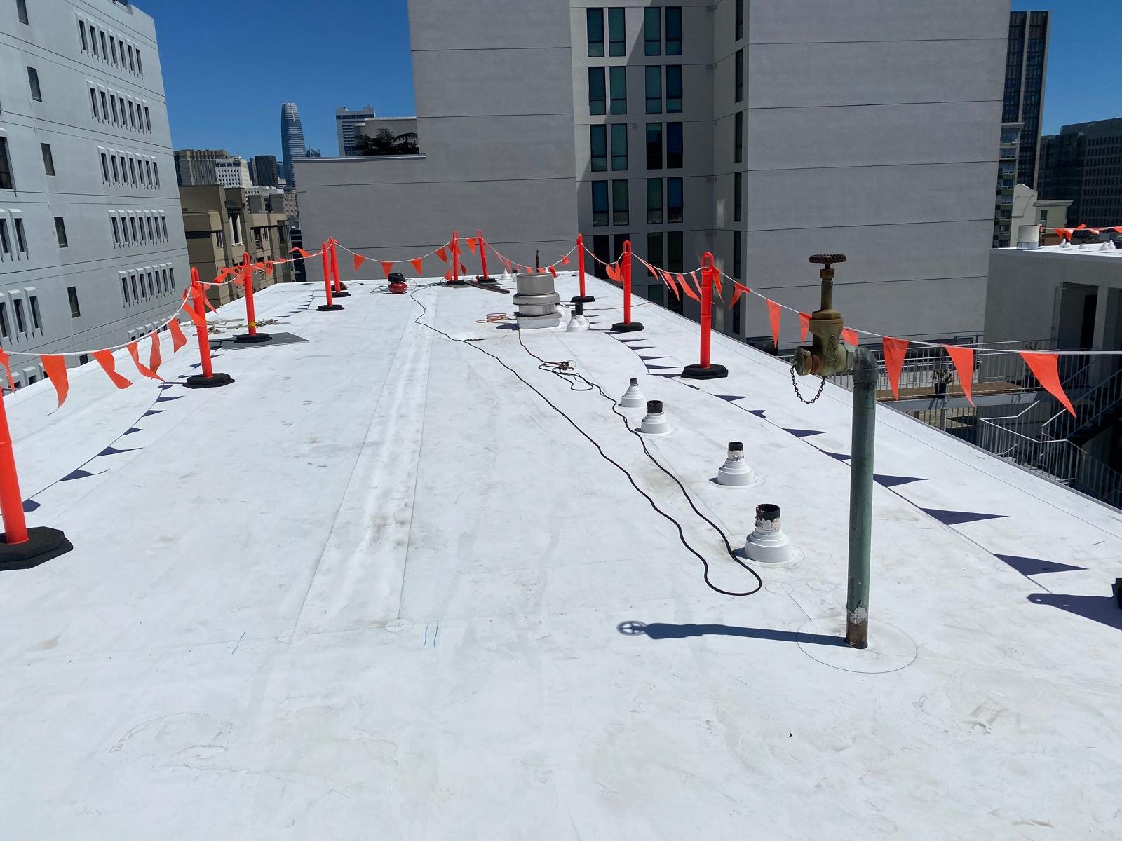 Completed commercial membrane roof in an urban setting